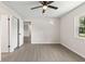 A spacious bedroom with hardwood floors and a ceiling fan at 2106 Umbrella Tree Dr, Edgewater, FL 32141