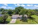 Well-manicured lawn and mature trees enhance the curb appeal of this lovely home at 2106 Umbrella Tree Dr, Edgewater, FL 32141