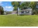 Charming single-story home boasts a well-manicured lawn, complemented by a driveway and attached garage at 2106 Umbrella Tree Dr, Edgewater, FL 32141