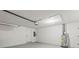 Clean and functional garage space featuring fresh white paint and utility connections at 2106 Umbrella Tree Dr, Edgewater, FL 32141