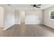 Open living room with wood floors, ceiling fan, and natural light at 2106 Umbrella Tree Dr, Edgewater, FL 32141
