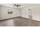 Bright, empty living room features new gray flooring, a ceiling fan, and a large window with a pleasant view at 2106 Umbrella Tree Dr, Edgewater, FL 32141
