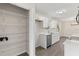 Well-organized pantry next to an updated kitchen with white cabinetry and quartz countertops, offering ample storage space at 2106 Umbrella Tree Dr, Edgewater, FL 32141