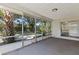 Large screened-in porch with tranquil views of the surrounding greenery at 2106 Umbrella Tree Dr, Edgewater, FL 32141