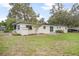 View of the home's backyard showcasing a well-manicured lawn and landscaping at 2215 Lake Ruby Rd, Deland, FL 32724