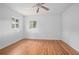 Bedroom with hardwood floors, two windows and a ceiling fan fixture at 2215 Lake Ruby Rd, Deland, FL 32724