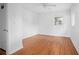 Minimalist bedroom featuring hardwood floors, white walls and natural light at 2215 Lake Ruby Rd, Deland, FL 32724