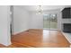 Dining room with hardwood floors, modern light fixture, slider, and view of the backyard at 2215 Lake Ruby Rd, Deland, FL 32724