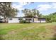Charming single-story home with well-maintained lawn, mature trees, and neutral color palette at 2215 Lake Ruby Rd, Deland, FL 32724
