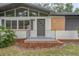 Charming home entrance with modern door, neat landscaping, and painted cinder block at 2215 Lake Ruby Rd, Deland, FL 32724