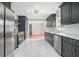 Modern kitchen featuring dark cabinetry, white backsplash, and stainless steel appliances at 2215 Lake Ruby Rd, Deland, FL 32724