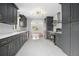 Beautiful kitchen with dark cabinetry, stainless steel appliances, and modern lighting at 2215 Lake Ruby Rd, Deland, FL 32724
