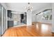 Open-concept kitchen featuring dark cabinetry, tile floors, and modern lighting fixtures at 2215 Lake Ruby Rd, Deland, FL 32724