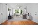 Staged living room with hardwood floors, ceiling fan, and large window views at 2215 Lake Ruby Rd, Deland, FL 32724
