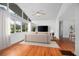Bright living room features hardwood floors, large windows, and a modern ceiling fan at 2215 Lake Ruby Rd, Deland, FL 32724