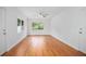 Sunlit living room with hardwood floors and large windows offering outdoor views at 2215 Lake Ruby Rd, Deland, FL 32724