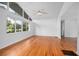 Bright living room featuring hardwood floors, large windows, vaulted ceiling, and modern fan at 2215 Lake Ruby Rd, Deland, FL 32724
