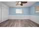 This bedroom boasts wood-look floors, natural light, and a clean, serene setting at 2226 Sherwood Dr, South Daytona, FL 32119