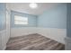 The empty bedroom features light blue walls, white trim, a window, and closet, offering a versatile living space at 2226 Sherwood Dr, South Daytona, FL 32119