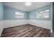 The empty bedroom features light blue walls, white trim, a window, and closet, offering a versatile living space at 2226 Sherwood Dr, South Daytona, FL 32119