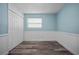 The empty bedroom features light blue walls, white trim, a window, and closet, offering a versatile living space at 2226 Sherwood Dr, South Daytona, FL 32119