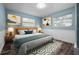 Relaxing bedroom with soft lighting, a plush bed, stylish art, and ample natural light, creating a cozy retreat at 2226 Sherwood Dr, South Daytona, FL 32119
