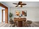 A dining room featuring seating for four, light wood floors, whitewashed brick, and a ceiling fan at 2226 Sherwood Dr, South Daytona, FL 32119