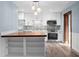 Updated kitchen features white cabinets, butcher block breakfast bar, and stainless steel appliances at 2226 Sherwood Dr, South Daytona, FL 32119