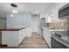 Modern kitchen features stainless appliances, white cabinets, and a convenient breakfast bar at 2226 Sherwood Dr, South Daytona, FL 32119
