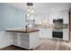 Bright kitchen features white cabinets, stainless steel appliances, and a mosaic tile backsplash at 2226 Sherwood Dr, South Daytona, FL 32119