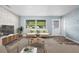 Inviting living room showcases a neutral color palette, brick accent wall, and durable wood-look flooring at 2226 Sherwood Dr, South Daytona, FL 32119