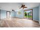 Bright living room with wood-look floors, natural light, and a view of the backyard at 2226 Sherwood Dr, South Daytona, FL 32119