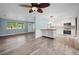 Open living and kitchen area with lots of natural light, wood floors, stainless steel appliances and modern accents at 2226 Sherwood Dr, South Daytona, FL 32119
