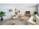 Comfortable living area featuring updated flooring, a brick accent wall, and seamless flow to other rooms at 2226 Sherwood Dr, South Daytona, FL 32119