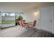 Covered porch with table and chairs, perfect for outdoor entertaining at 2226 Sherwood Dr, South Daytona, FL 32119