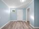 Light blue room with new floor, window and walk in closet, bright and airy at 2226 Sherwood Dr, South Daytona, FL 32119