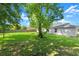 Expansive backyard featuring lush greenery and shade, ideal for outdoor activities at 2747 Date Palm Dr, Edgewater, FL 32141