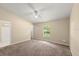 Neutral bedroom with ceiling fan and window providing natural light at 2747 Date Palm Dr, Edgewater, FL 32141