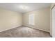 Neutral bedroom with carpet, base molding, and window with blinds at 2747 Date Palm Dr, Edgewater, FL 32141