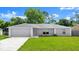 Charming single-story home with a well-maintained lawn and attached two car garage at 2747 Date Palm Dr, Edgewater, FL 32141