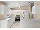 Bright kitchen with white cabinets, modern appliances, and a functional layout at 2747 Date Palm Dr, Edgewater, FL 32141
