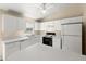 Bright kitchen features white cabinets, stainless steel appliances, and ample counter space at 2747 Date Palm Dr, Edgewater, FL 32141