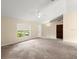Bright living room with large windows and neutral walls, creating a welcoming atmosphere at 2747 Date Palm Dr, Edgewater, FL 32141