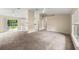 Spacious living room with plush carpeting and sliding glass doors to the backyard at 2747 Date Palm Dr, Edgewater, FL 32141