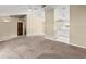 Open-concept living area with carpet flooring and access to the kitchen and bedrooms at 2747 Date Palm Dr, Edgewater, FL 32141
