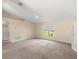 Inviting living room with carpet flooring and ample natural light from the large window at 2747 Date Palm Dr, Edgewater, FL 32141