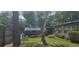 Quaint home exterior with lush green yard and covered parking at 27751 Luella Ave, Paisley, FL 32767