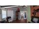 Open living space with beam ceilings and a view into a bonus room at 27751 Luella Ave, Paisley, FL 32767