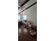 Spacious room with hardwood floors, beam ceiling, and natural light at 27751 Luella Ave, Paisley, FL 32767