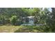 Charming shed surrounded by lush greenery, adding storage and character to the backyard at 27751 Luella Ave, Paisley, FL 32767